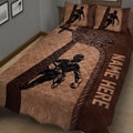 Close view of brown lineman quilt blanket featuring a power lineworker and electrical equipment