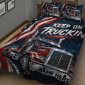 Close-up of a trucker quilt blanket featuring red semi-trucks, stars, and bold red, white, and blue graphics