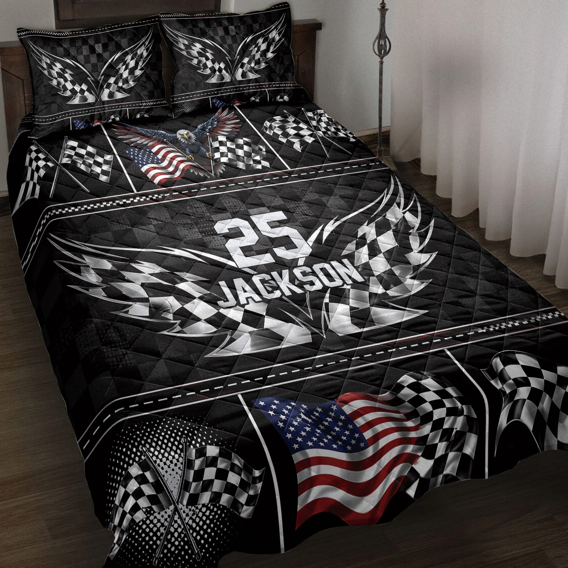 Racing quilt blanket displayed on a bed with checkered flags, eagle artwork, and bold black, white, and red details