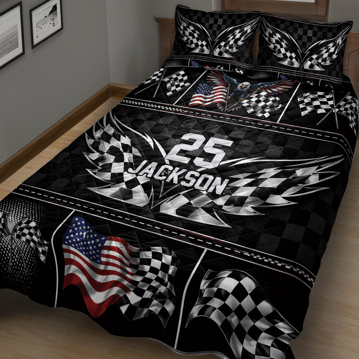 Close bedroom view of racing quilt blanket featuring crossed checkered flags, eagle artwork, and bold geometric patterns