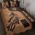 Barrel racing quilt blanket displayed on a bed with western horse and rider artwork in brown and black
