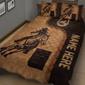 Barrel racing quilt blanket in a bedroom featuring a mounted rider, horse, horseshoe, and western colors