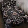 Australian Cattle Dog quilt blanket displayed on a bed with black geometric artwork and multiple dog portraits