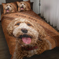Goldendoodle quilt blanket in warm brown tones with joyful dog portraits across the bed