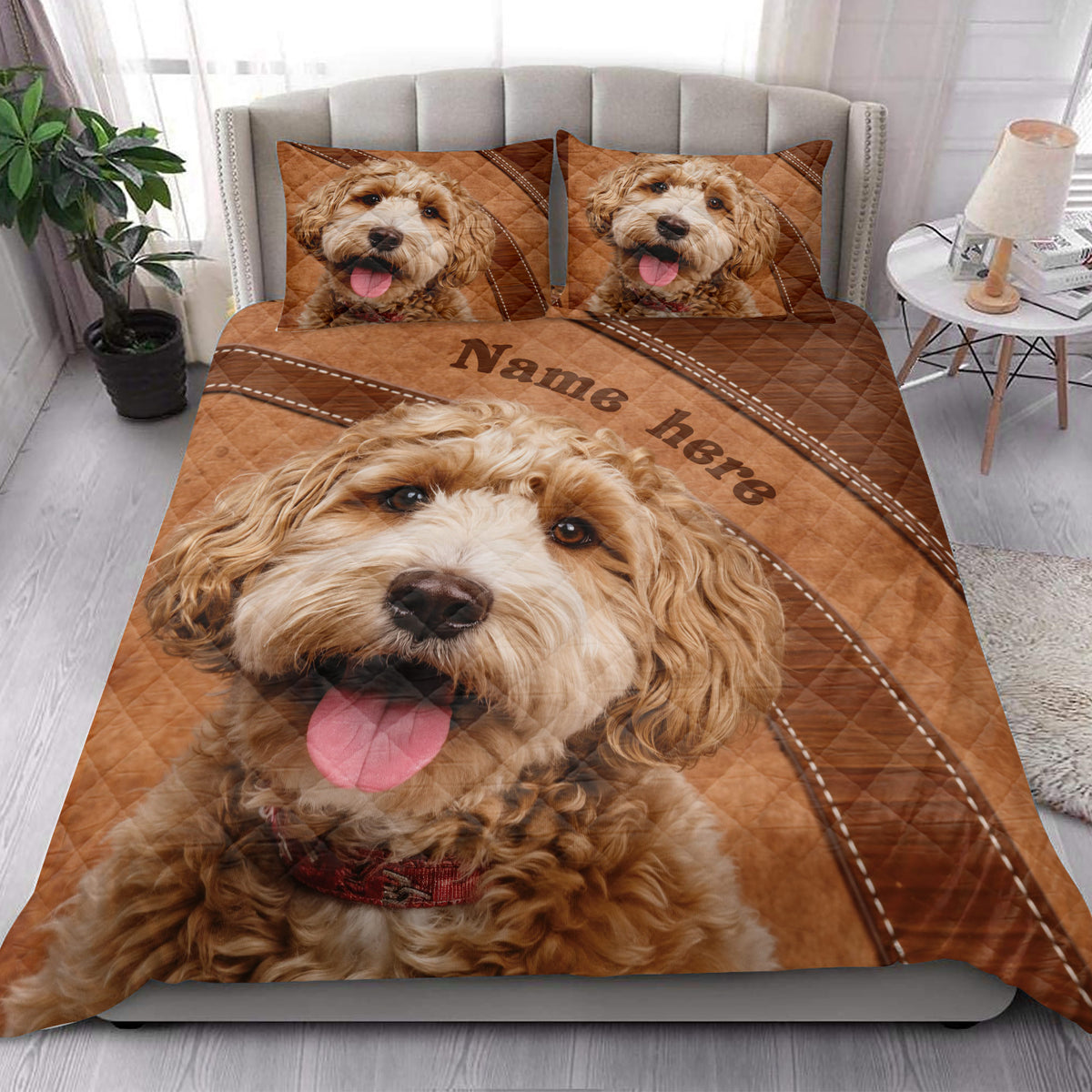 Goldendoodle quilt blanket styled on a modern bed with large dog portrait artwork