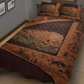 Close view of a camping quilt blanket featuring an RV, forest landscape, mountains, compass, backpack, and camp stove