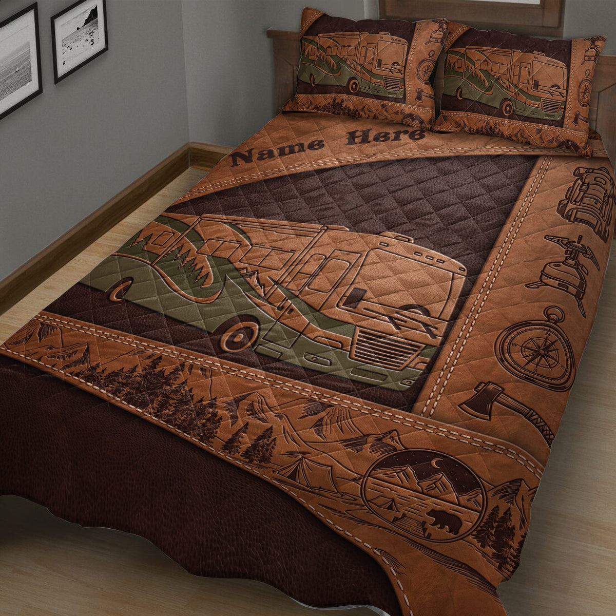Close view of a camping quilt blanket featuring an RV, forest landscape, mountains, compass, backpack, and camp stove