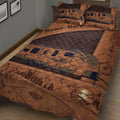 Rustic camping quilt blanket on a bed with RV, compass, backpack, mountain, forest, lake, and tent artwork