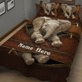 Close bedroom view of a brown elephant quilt with detailed elephant artwork and coordinating pillows