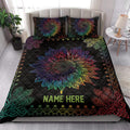Rainbow sunflower quilt blanket styled across a bed with matching sunflower pillow designs