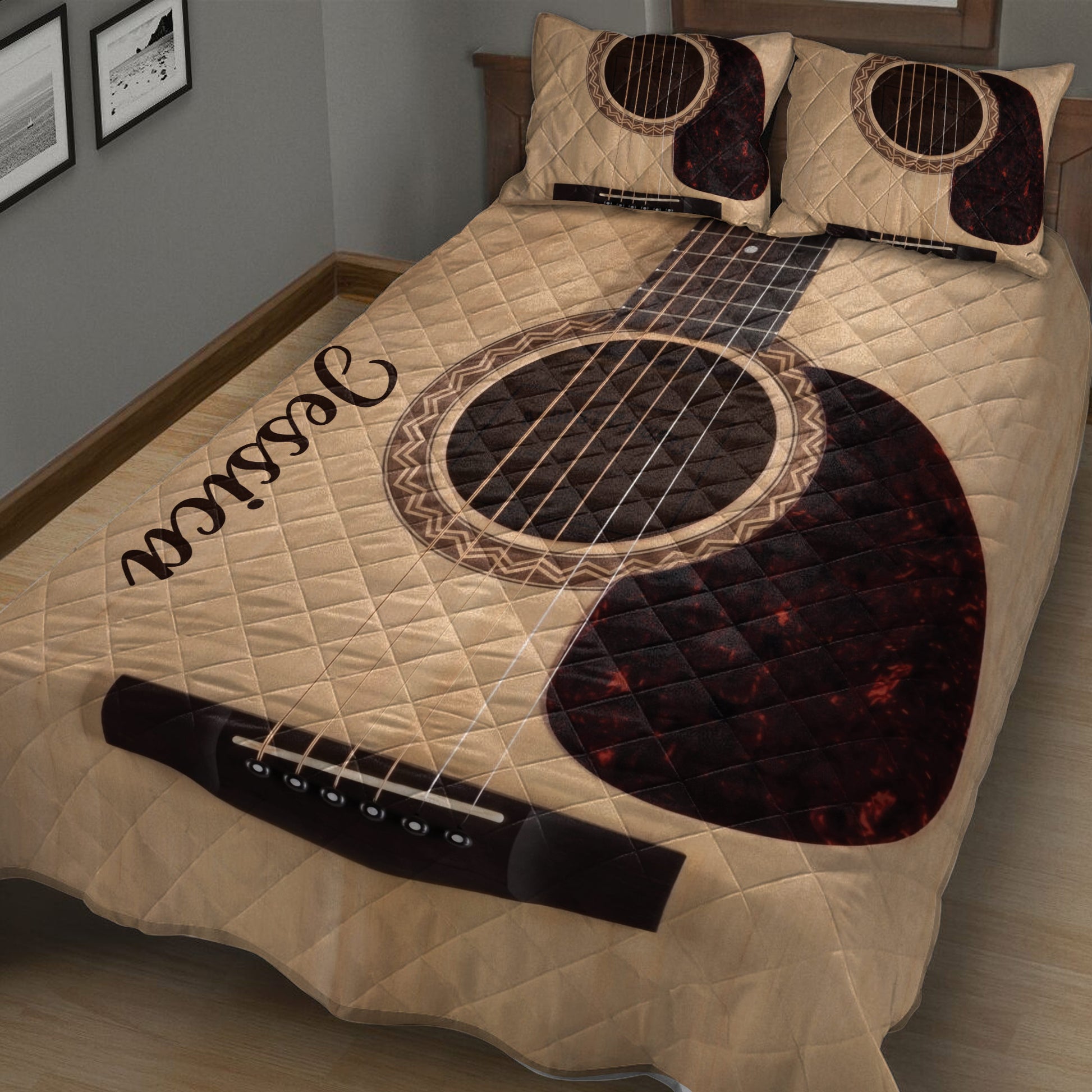 Close view of acoustic guitar artwork across a quilt blanket and coordinating bedding