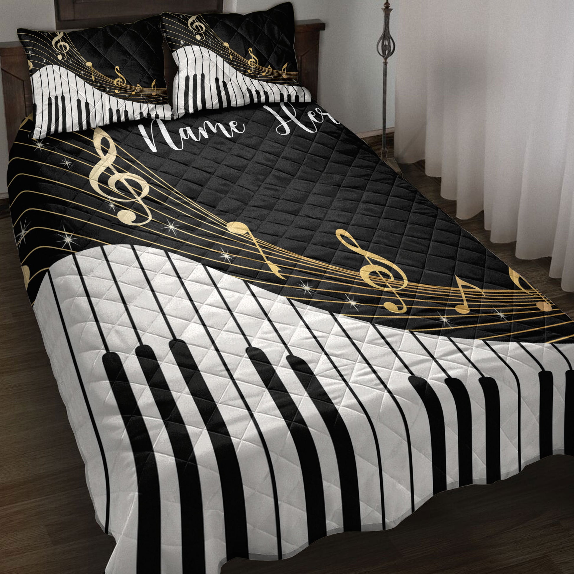 Black and white piano key quilt blanket with gold musical notes styled on a bedroom bed