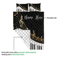 Piano quilt blanket close-up showing musical notes, piano keys, quilted texture, and printed surface