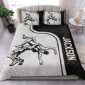 Wrestling quilt bedding styled in a modern bedroom with bold black and white artwork
