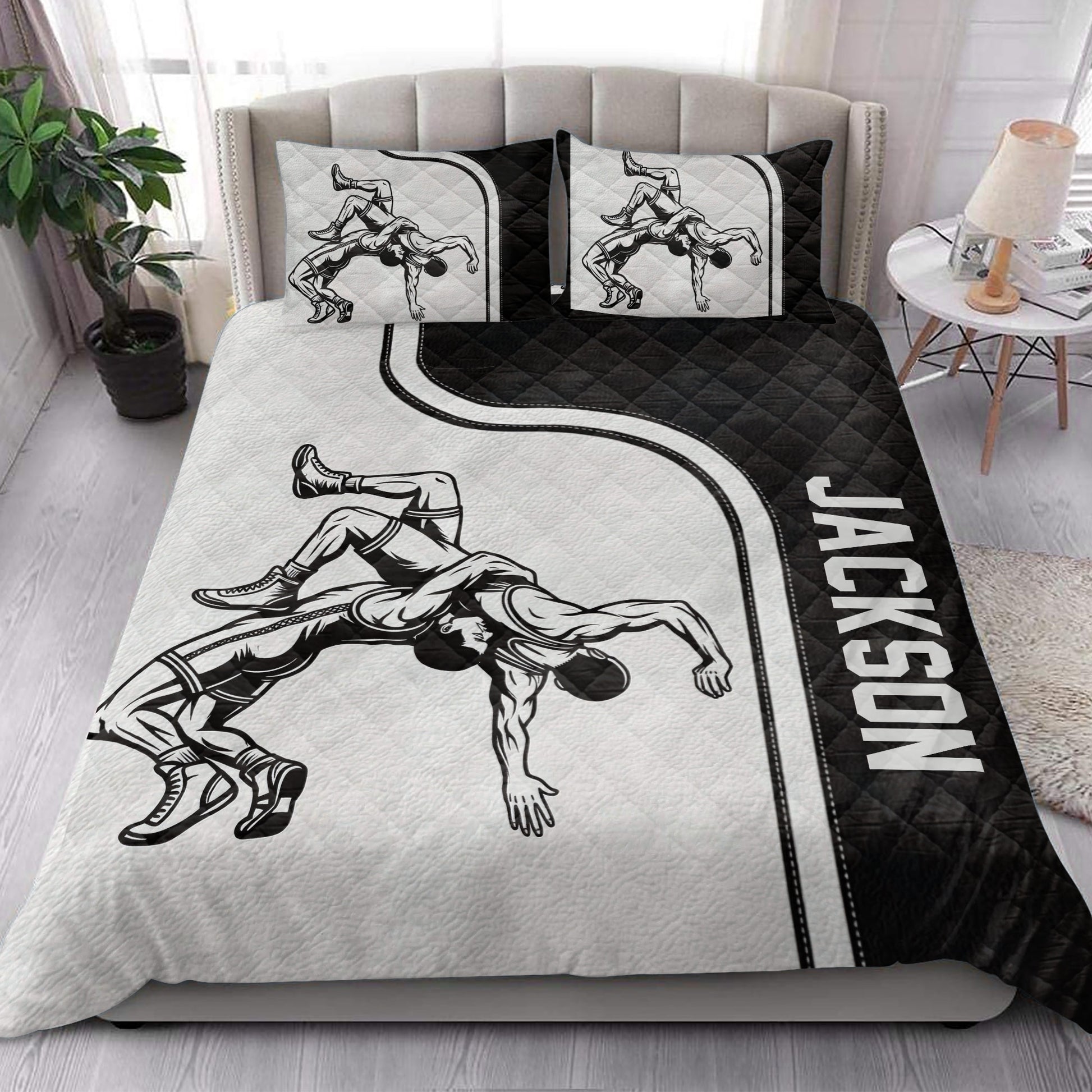 Wrestling quilt bedding styled in a modern bedroom with bold black and white artwork