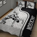 Close view of wrestling quilt blanket featuring grappling artwork and contrasting black border