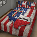 Angled bedroom view of a Texas quilt blanket featuring a large Lone Star motif and distressed flag design