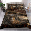 Rustic deer quilt blanket styled in a bright bedroom with buck artwork, antlers, mountains, and forest scenery