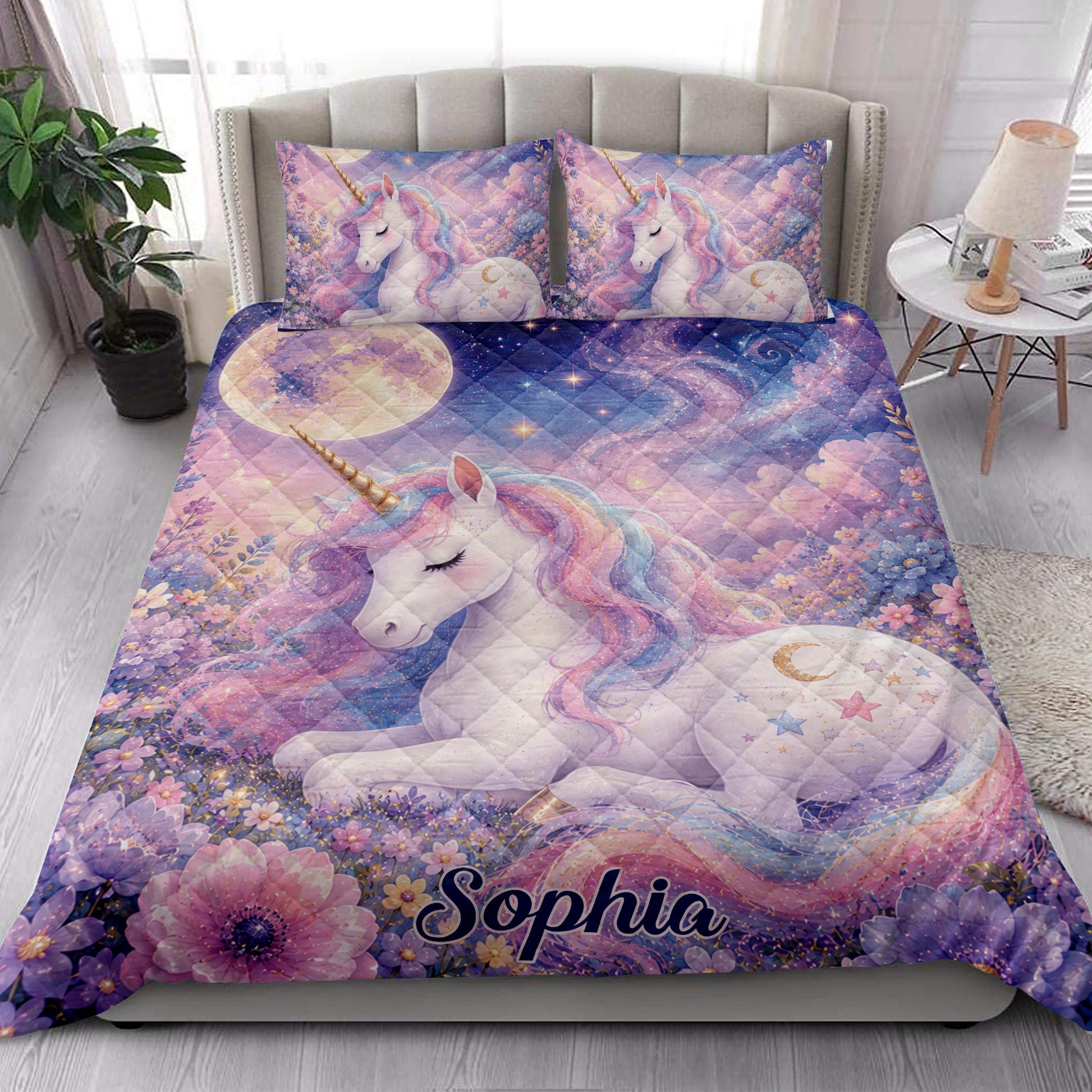 Dreamy unicorn quilt blanket styled on a bedroom bed with pastel flowers, stars, and galaxy details