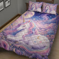 Close bedroom view of a pastel unicorn quilt blanket with sleeping unicorn artwork and floral borders