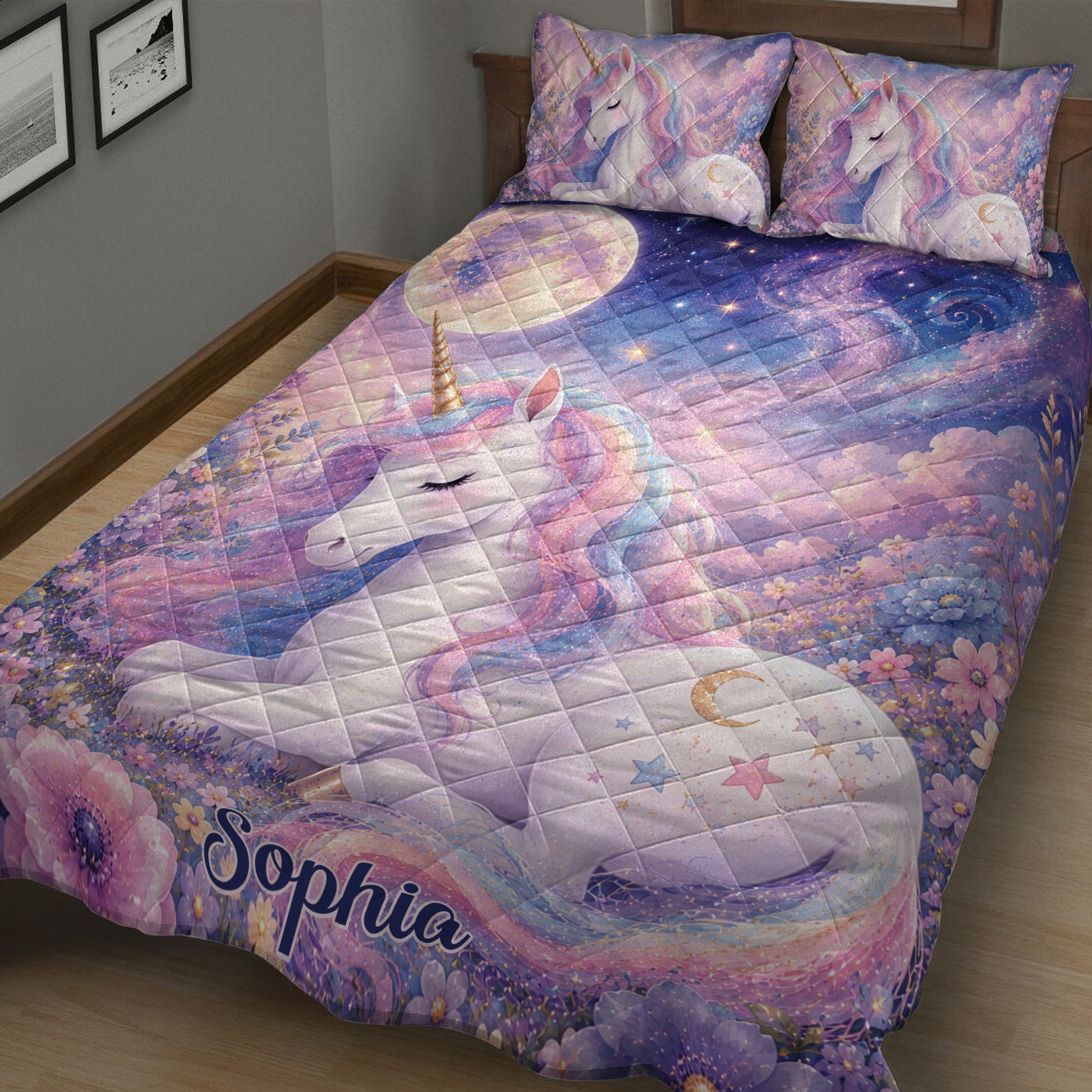 Close bedroom view of a pastel unicorn quilt blanket with sleeping unicorn artwork and floral borders