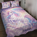 Pastel unicorn quilt blanket spread across a bed with matching dreamy rainbow artwork