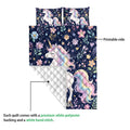 Unicorn quilt blanket showing the printed floral side and white quilted backing