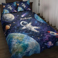 Astronaut quilt bedding set displayed on a bed with planets, rockets, stars, and colorful space artwork