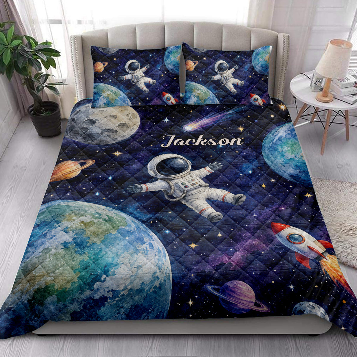 Astronaut quilt blanket styled in a bright bedroom with planets, rockets, stars, and space artwork