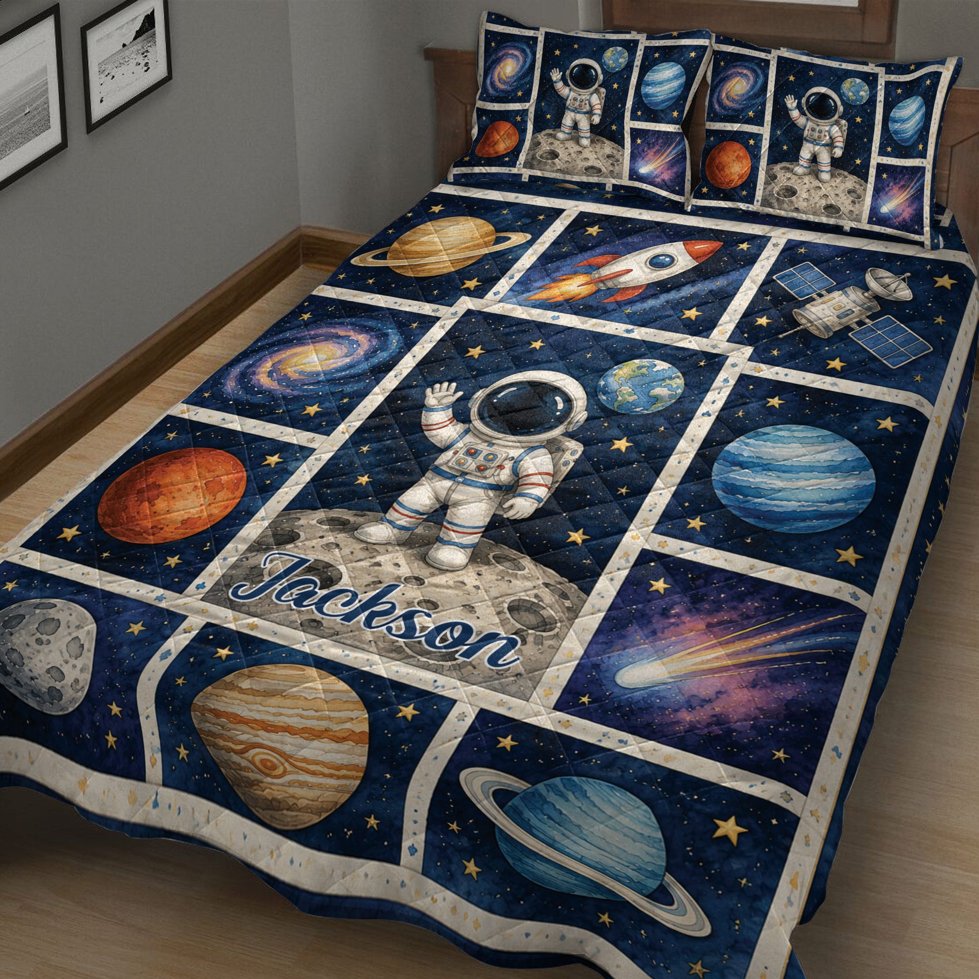 Close view of astronaut quilt blanket with planets, stars, rocket, satellite, and deep blue space design