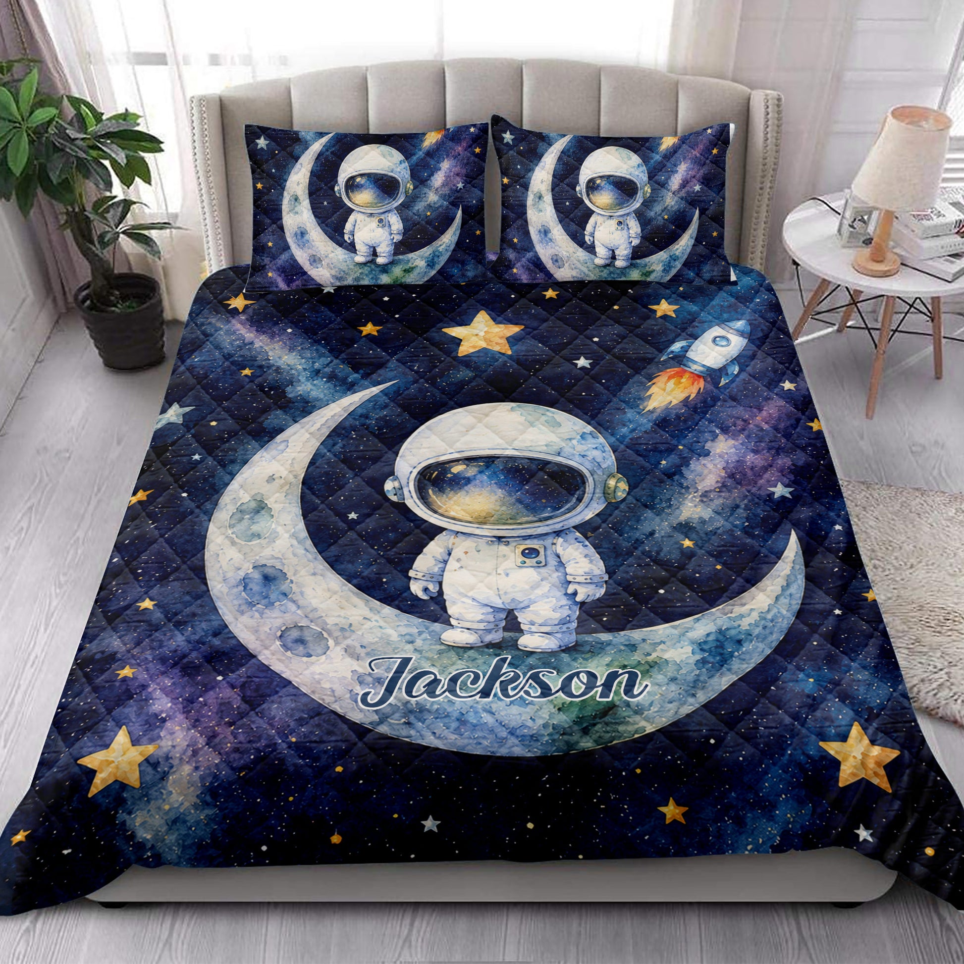Astronaut quilt bedding set styled in a bedroom with moon, rocket, star, and galaxy artwork