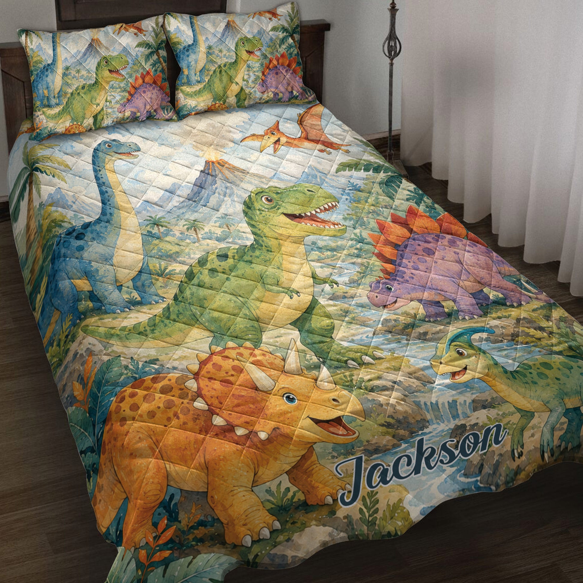 Dinosaur quilt blanket displayed on a bed with colorful dinosaurs, volcanoes, palms, and prehistoric scenery