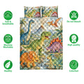 Dinosaur quilt bedding set shown flat with colorful prehistoric artwork and two matching pillowcase designs