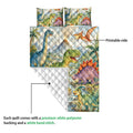 Dinosaur quilt detail showing the printed artwork side and white diamond-quilted reverse