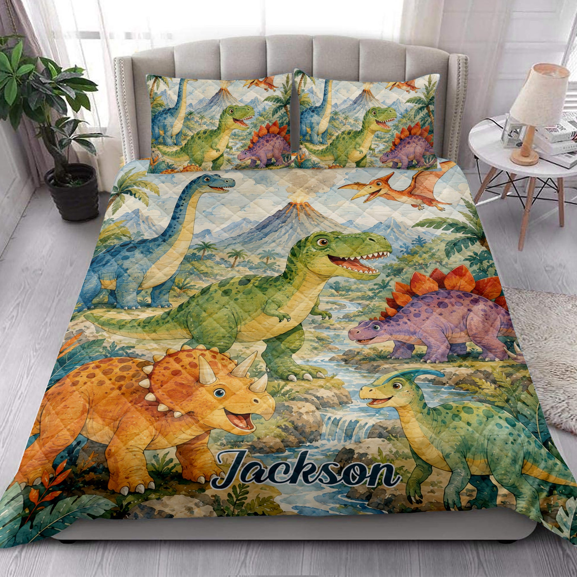 Dinosaur quilt blanket styled in a bright bedroom with colorful dinosaurs and prehistoric landscape artwork