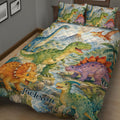 Dinosaur quilt spread across a bed with green, blue, purple, and orange dinosaur artwork