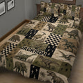Close bedroom view of a dinosaur quilt blanket featuring vintage dinosaur illustrations, checkerboard blocks, and lightning motifs
