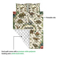 Dinosaur quilt showing the printed front and white quilted reverse side