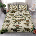 Dinosaur quilt bedding styled in a bright bedroom with tropical foliage and prehistoric animal artwork