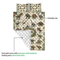 Dinosaur quilt showing its printed front, white quilted backing, and finished hand-stitched construction