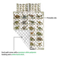 Close view of dinosaur alphabet quilt showing printed animal artwork and quilted white backing
