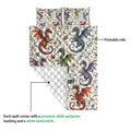 Dragon quilt showing the printed artwork side and white diamond-stitched backing