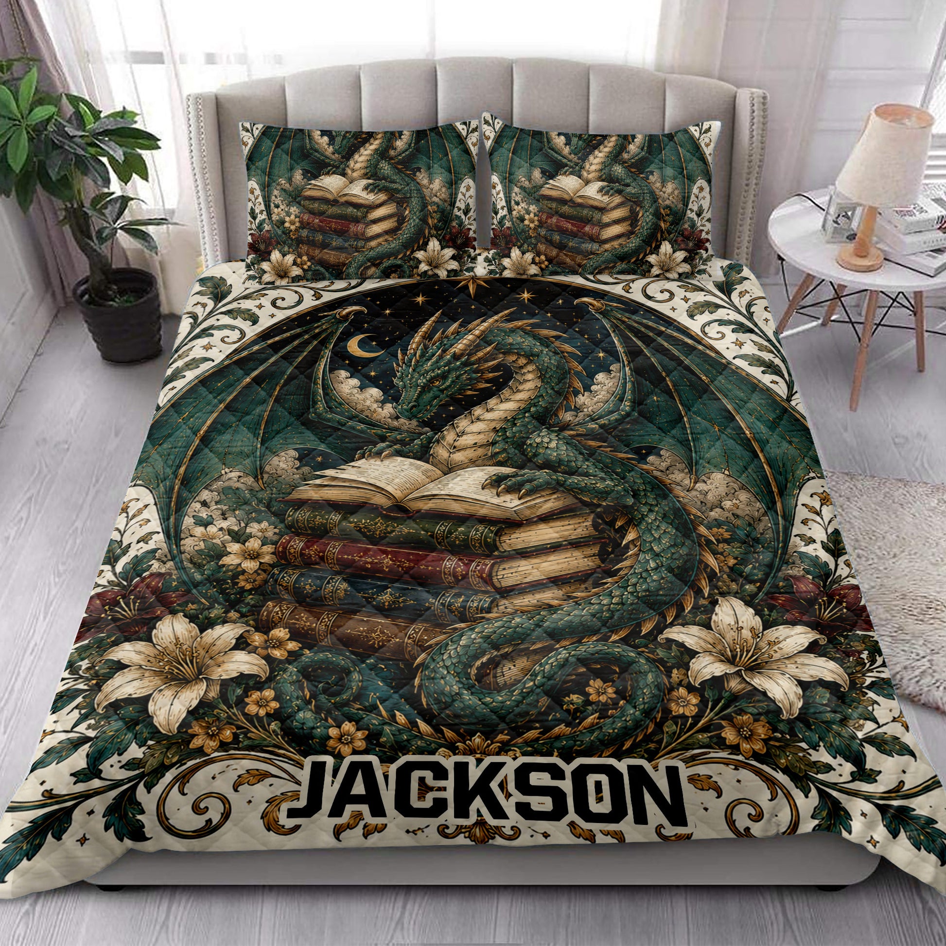 Dragon quilt bedding styled in a bright bedroom with a winged dragon, books, and floral details