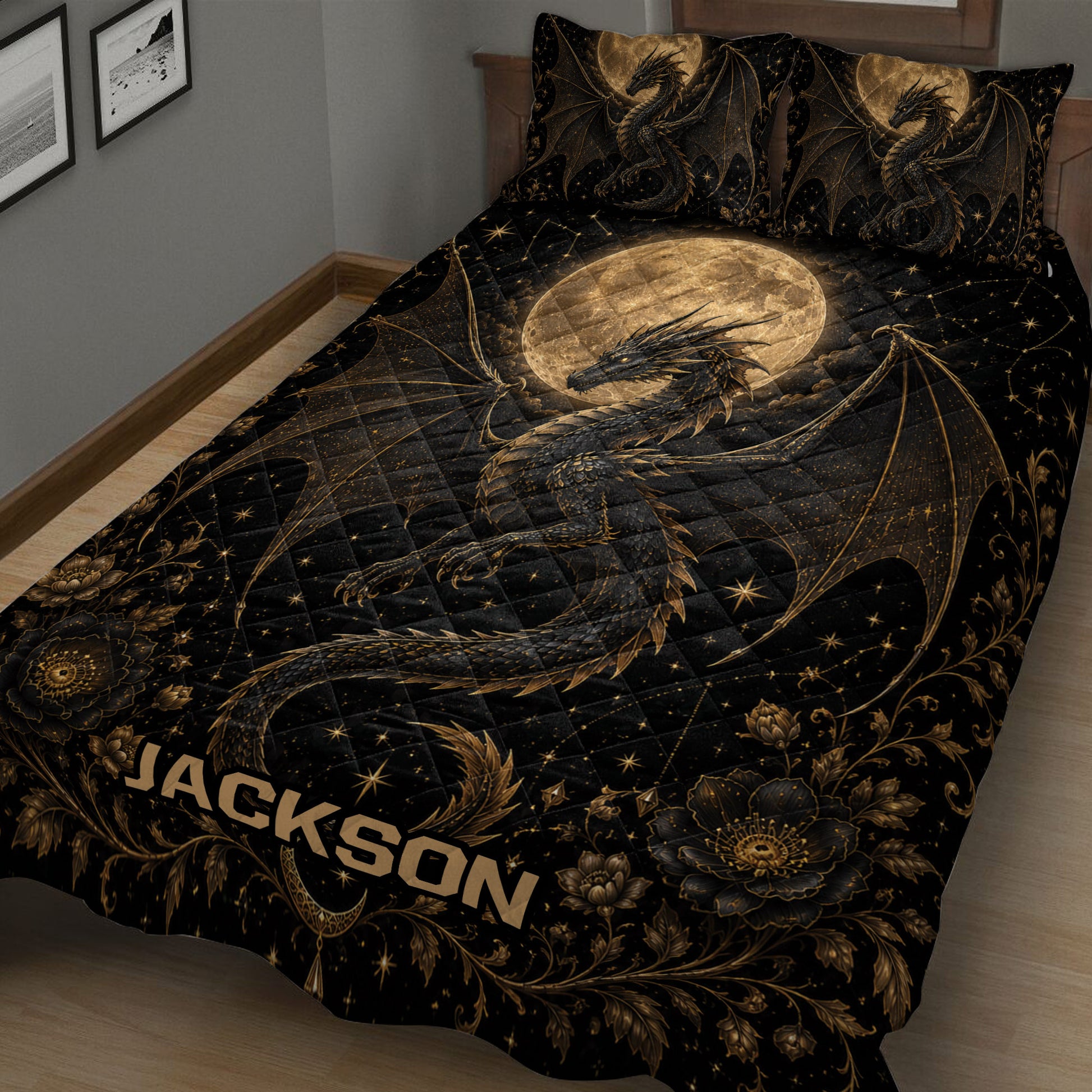 Angled bedroom view of a black dragon quilt blanket with moonlit wings, stars, and ornate floral borders