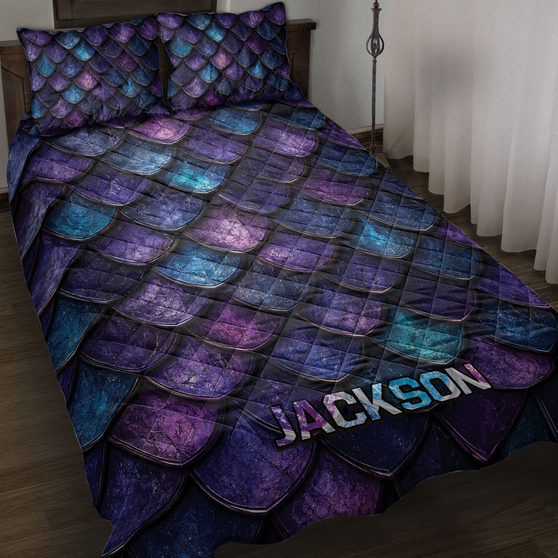 Dragon-inspired quilt blanket with layered purple, blue, and teal scales styled on a bedroom bed