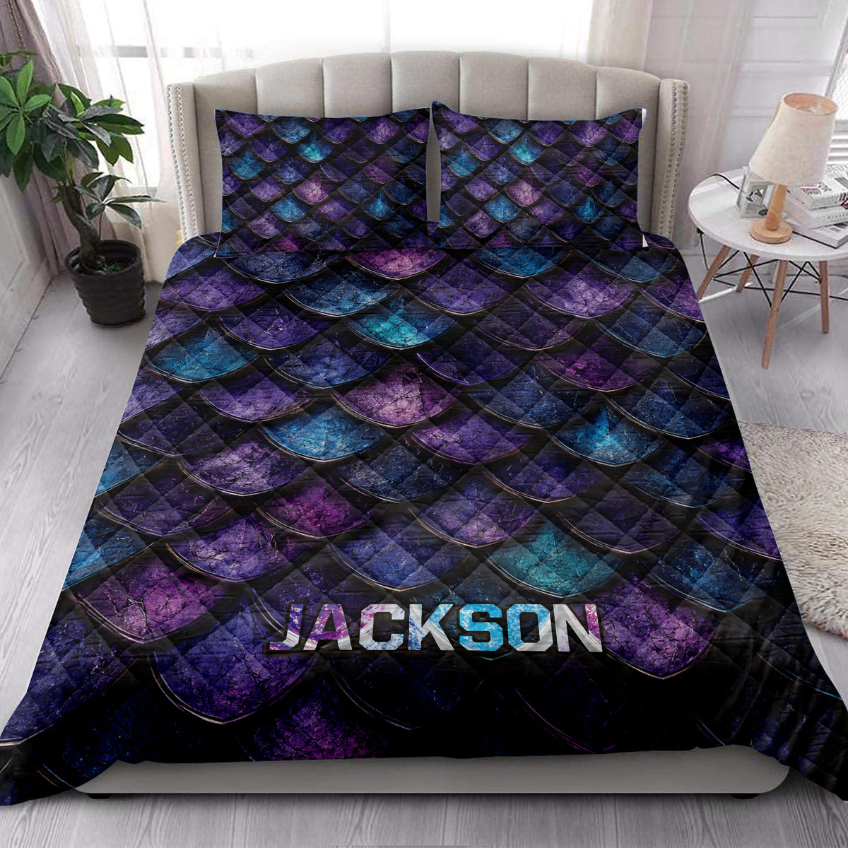 Dragon-inspired quilt blanket styled across a bedroom bed with coordinated scale-pattern pillows