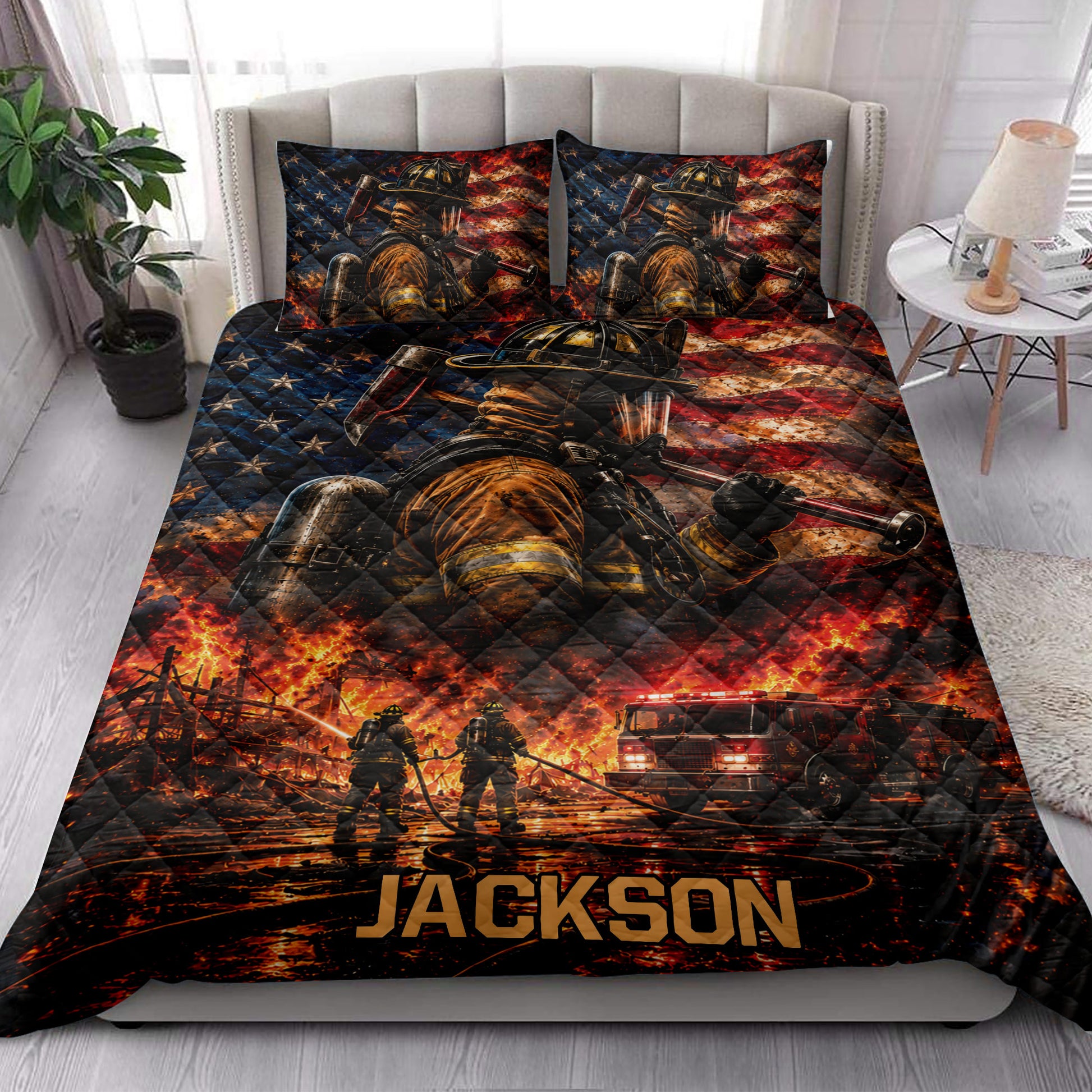 Firefighter quilt blanket styled on a bed with dramatic flames, firefighters, fire trucks, and flag artwork