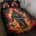 Firefighter quilt blanket displayed on a bed with dramatic flames, dark smoke, and bold red and gold artwork