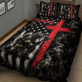 Angled bedroom view of a firefighter quilt blanket featuring protective gear, smoke, stars, and red graphics