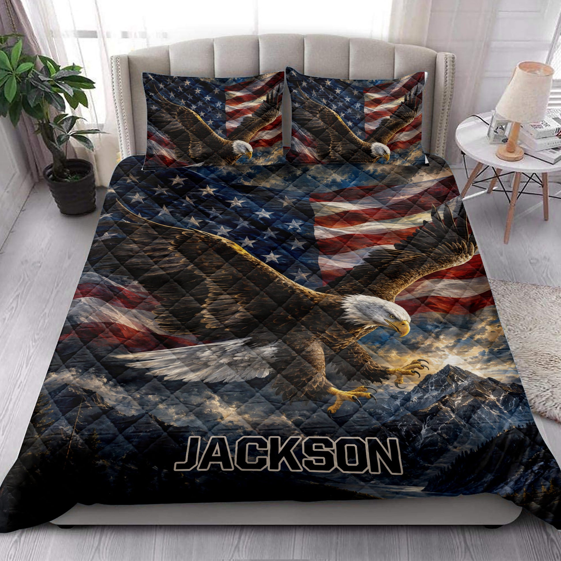 Eagle quilt bedding styled in a bright bedroom with bald eagle, mountain, and American flag artwork